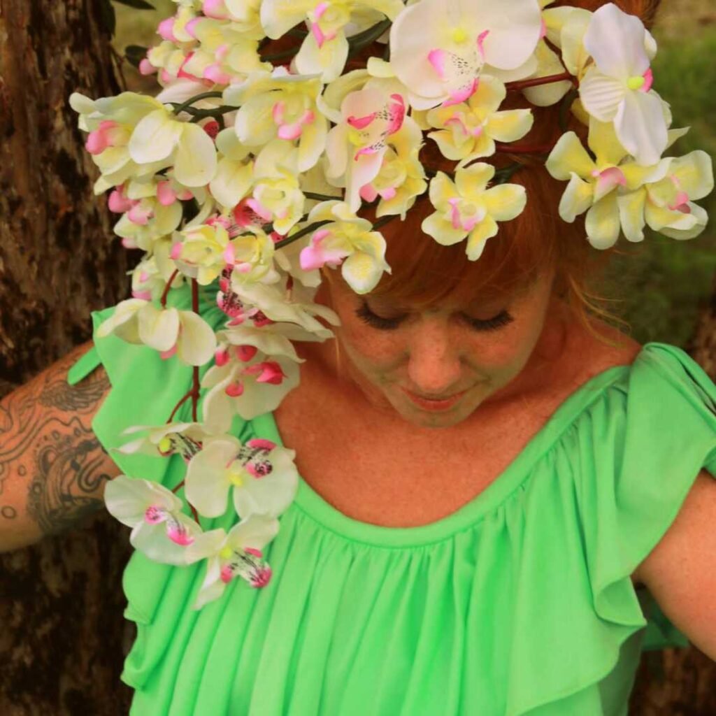 Talitha, close up portrait image, with a bouquet of flowers in her hair. Australian psychic, medium, tarot.